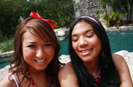 Asian lesbian teens reveal amazing butts and big boobs playing near a pool