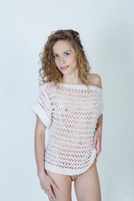 Young girl with curly hair Dennie gets completely naked in a confident manner