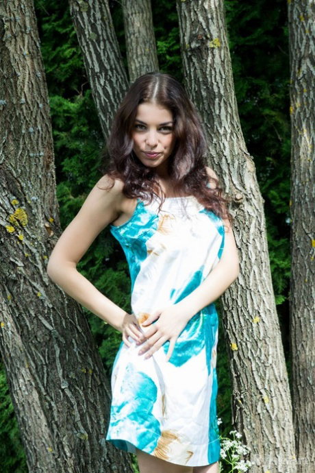 Nice teen Evita Lima exposes her great body at the edge of a forest