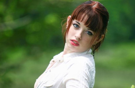 Amateur girl with red hair Barbie A exposes her tits while in a grassy field