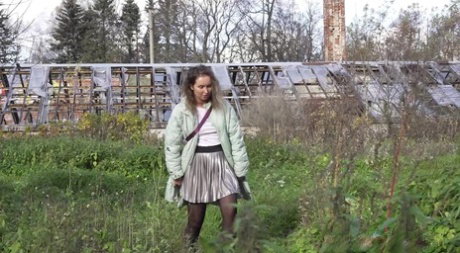 White girl Rita takes a piss by an abandoned building while taking a shortcut