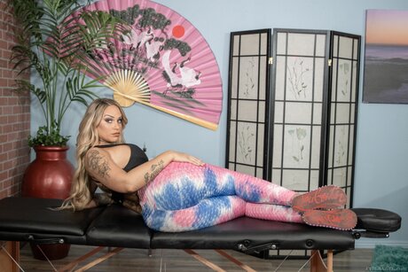 Tattooed blonde rides on top her submissive male masseur