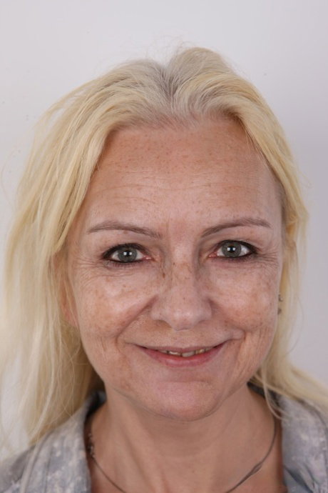Older blonde woman gets completely naked on a stool for the first time