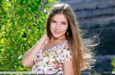 Cute teen Vivian puts the focus on her landing strip twat while naked outdoors