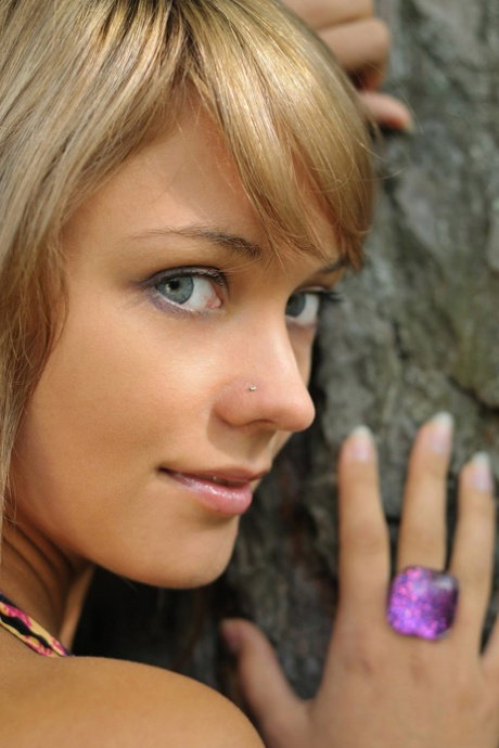 Sweet teen with blue eyes Lada D reveals her small breasts in the woods