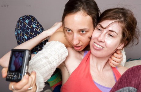 Young brunette lesbian lovers rubbing small tits together before oral sex