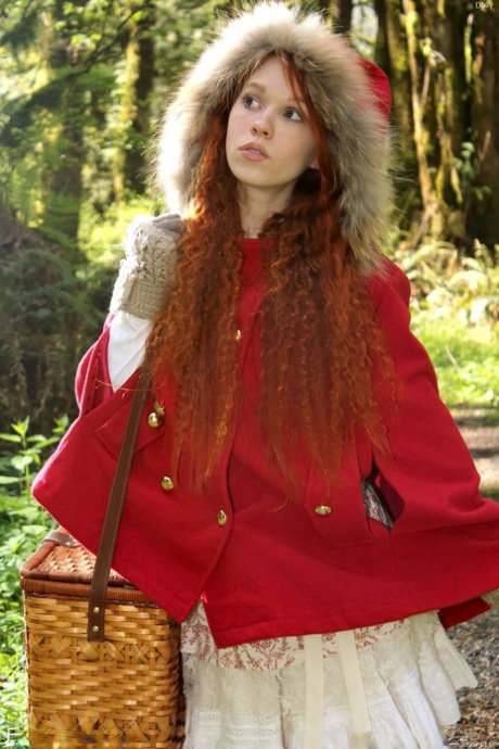 Tiny redhead teen Dolly enjoys solo masturbation with bananas in the forest