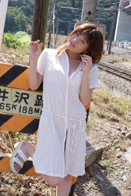 Japanese teen Kyoko Nakajima poses nude on rail tracks and inside her home