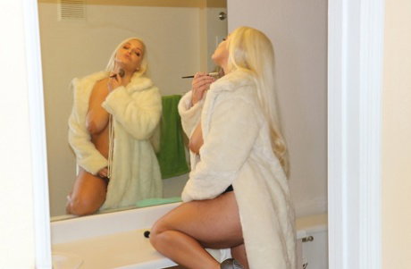 Platinum blonde eescort Macy Cartel jerks a big dick wearing a fur coat