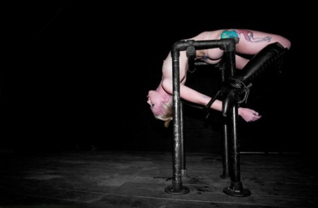 Kinky blonde babe Sarah Jane Ceylon hangs upside-down in a BDSM dungeon