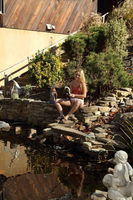 Blonde girl Sara Jaymes gets naked while fishing with a rod and reel