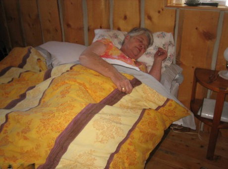 Obese granny Girdle Goddess wakes up from a nap and precedes to strip naked