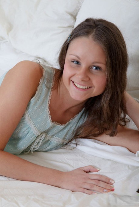 Young looking girl Liza Shay gets bare naked before toying her pussy