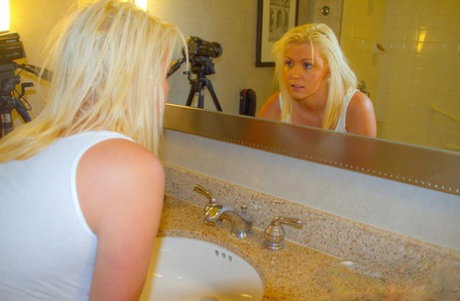 Blonde amateur Brooke Alexander releases her large boobs from a wet shirt