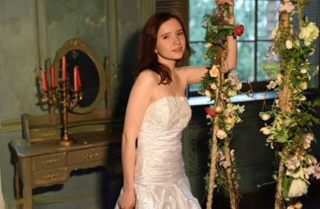 Sweet teen Jennifer removes an elegant gown to model in the buff