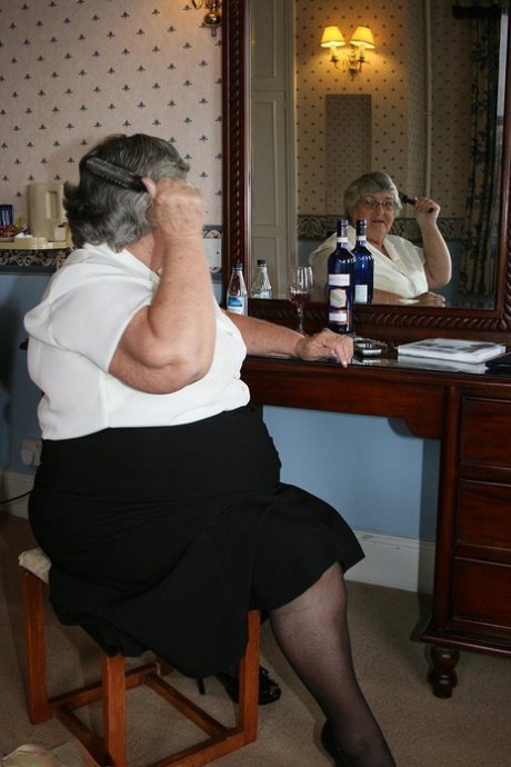 Fat grandmother with short grey hair has phone sex in black stockings only