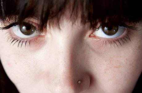 Pierced young girl Pennylaine gets undressed in hot close up action
