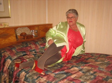 Fat granny Girdle Goddess pets her pussy after stripping to hosiery on her bed