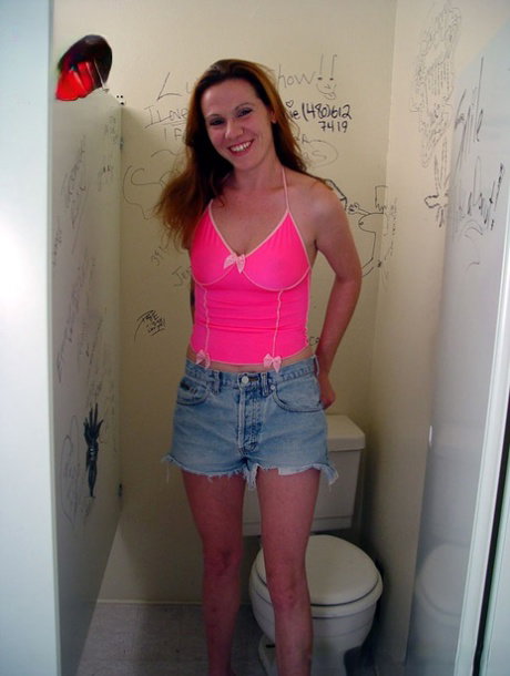 Horny babe with natural tits Dayna strips and tastes a black gloryhole dong