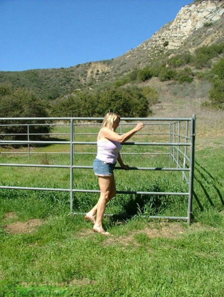 Blonde amateur Adonna exposes her overweight body in a horse paddock