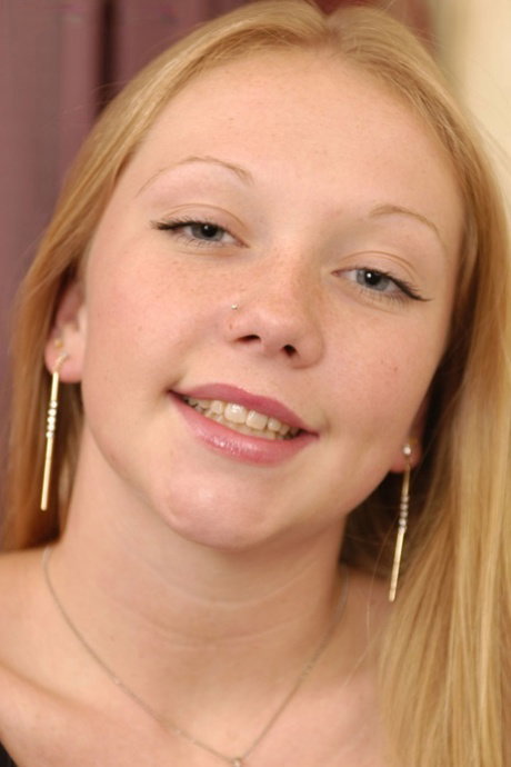 Strawberry blonde amateur Neveah fingers her pink pussy during a closeup
