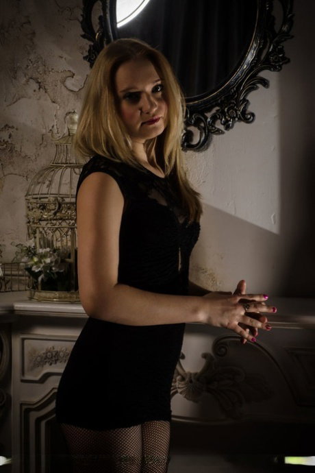 Young blonde Rusa ditches a black dress before touching her nipples and pussy