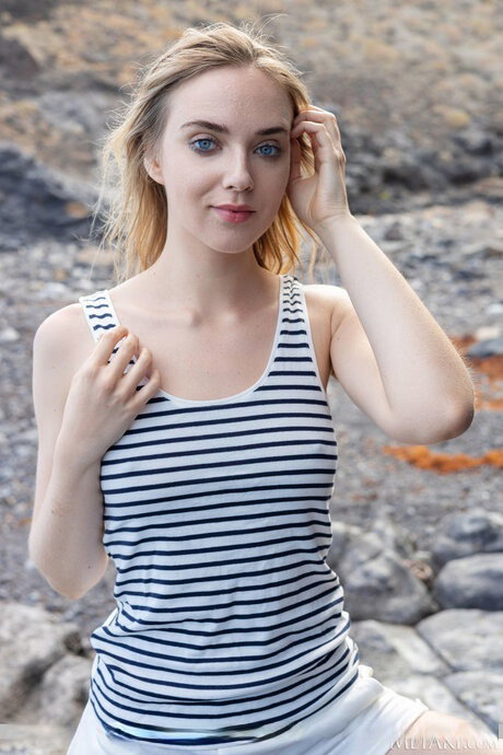 Skinny teen Oxana Chic gets totally naked while scaling a rock face