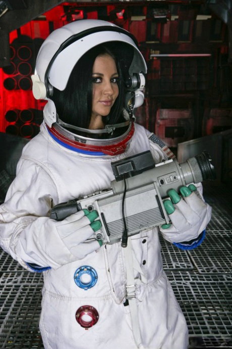 Stunning MILF Audrey Bitoni takes her space suit off and fingers her wet cunt