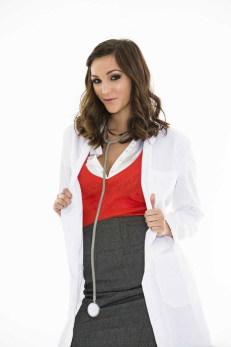 Brunette nurse Holly Michaels does a sexy striptease in stockings & high heels