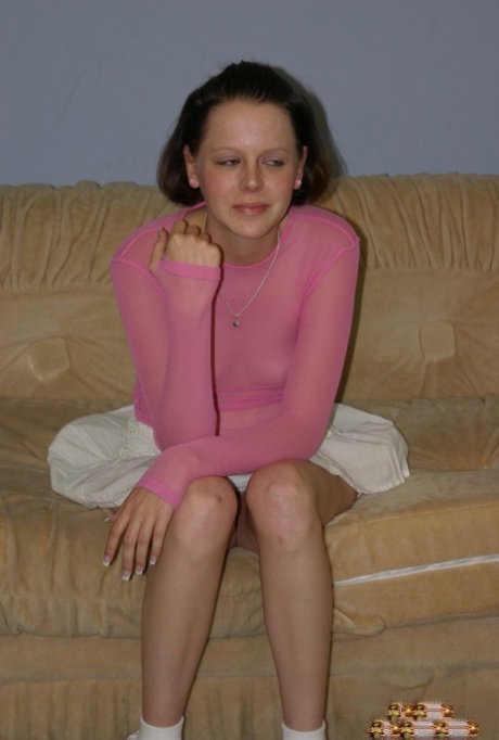 American solo girl shows off her bare ass in a see thru top on a couch