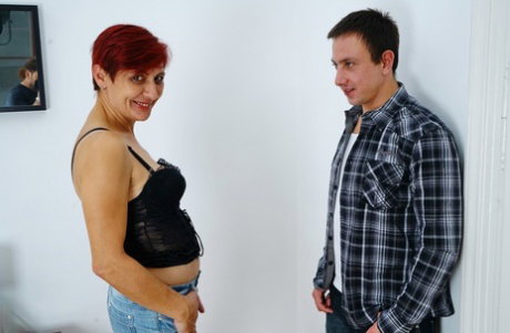 Short haired older redhead gets banged on a her bed by her younger lover