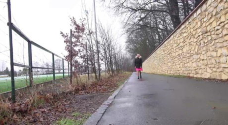 Blonde chick Claudia Macc takes a piss alongside a paved roadway