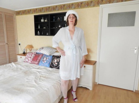 Hot granny Kat Kitty in sheer white lingerie toying her wet pussy with dildo