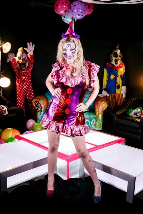 Blonde clown stripper Leya Falcon reveals her tits and poses in high heels