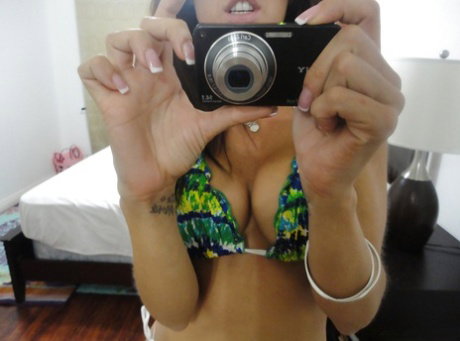 Hot babe Capri Cavanni takes self shots exposing big tits and body in bikini