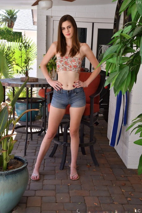 Pretty girl Lily makes her nude modelling debut on a veranda