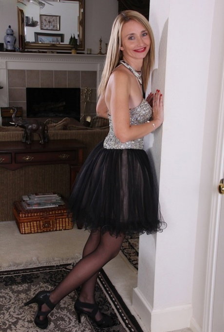 Classy older woman Heidi Van Moore shedding sexy skirt to reveal hairy pussy