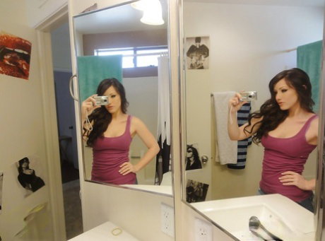 Glamorous young babe Jennifer White makes some self shots in a bathroom