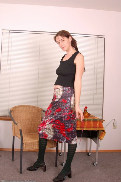Solo girl displays her bush after stripping to over the knee socks