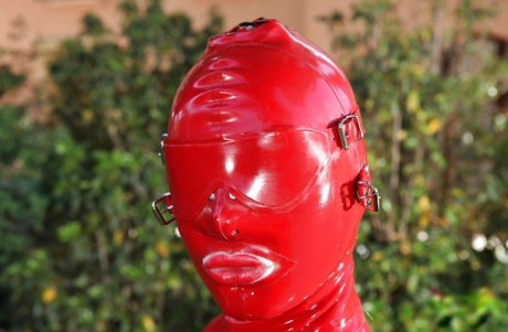 Voluptuous fetish vixen in latex suit revealing her juicy cunt outdoor
