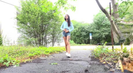 Skinny girl Mistica gets caught taking a piss on a paved path
