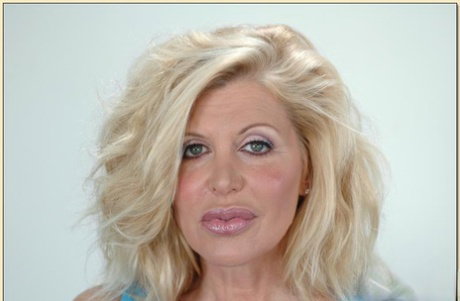 Busty mature Sharon Kane strips from lingerie and shows hairy slit
