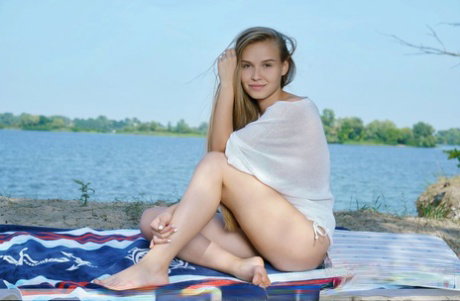 Solo model Pam E gets completely naked on a beach towel near a lake
