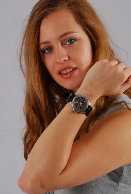 Pretty redhead Jennifer displays her Citizen diver's watch while fully clothed