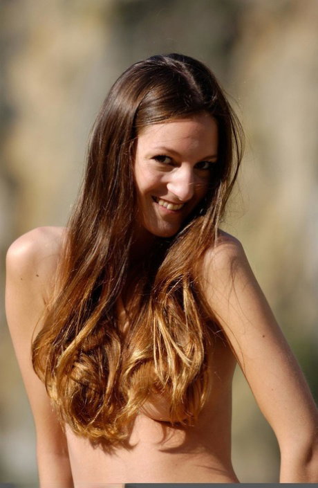 Skinny teen Marie Anne models totally naked on boulders overlooking a river
