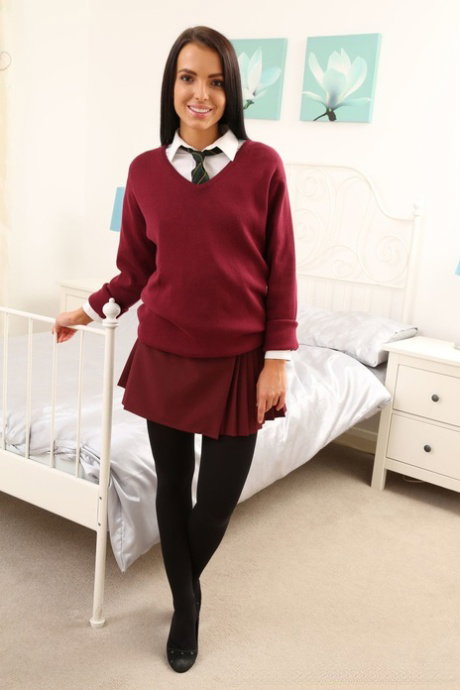 Beautiful schoolgirl Sapphira doffs her uniform and teases with her titties