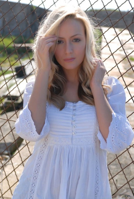 Cute blonde babe Alana Chase posing in her gorgeous outfit outdoors