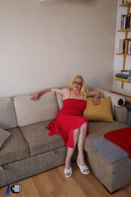 Kinky blonde mature in glasses Celeste lifts up her red dress & grabs her ass