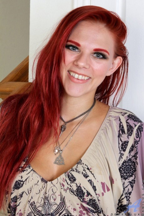 Natural redhead Devyn Lux fingers her tattooed pussy after disrobing
