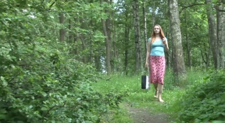 Barefoot girl Lena June takes a piss while on a walk through a forest